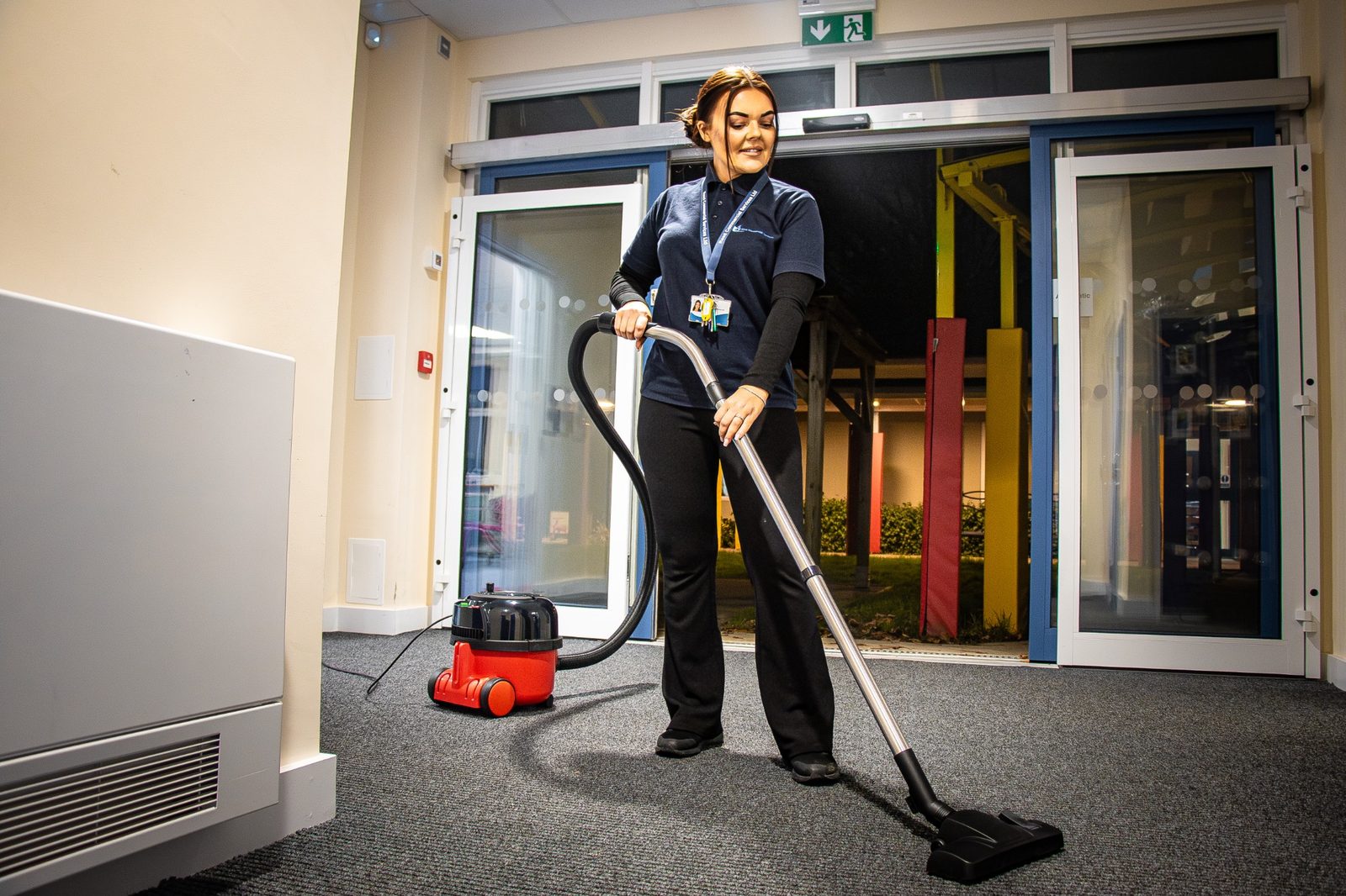 Reed cleaner vacuuming a commercial entrance