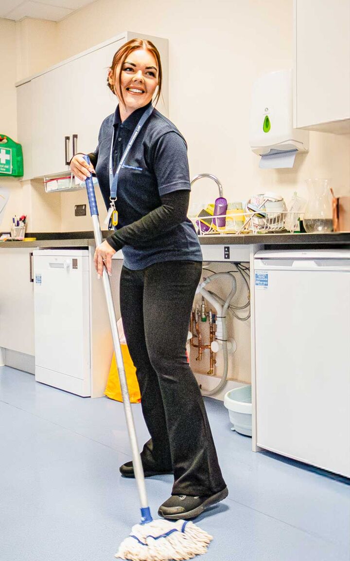 Reed cleaner mopping a staff kitchen floor